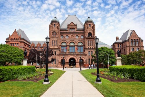 An ornate building with a lawn in front of it.